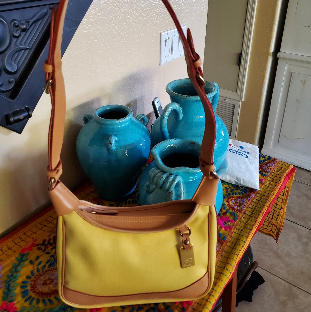 Dooney and Burke Pastel yellow long strap purse